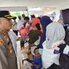 Tampak Kapolres Teluk Bintuni, AKBP Choirudin Wachid, bercengkrama dengan seorang Ibu yang sedang menggendong anaknya. 