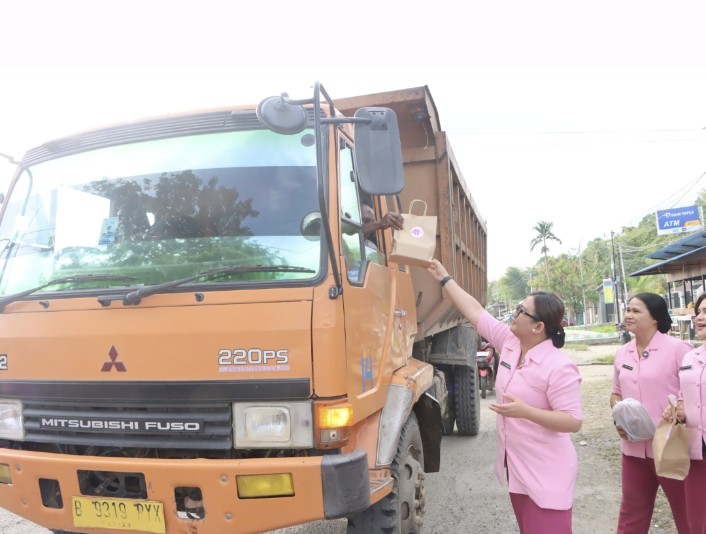Ketua Pengurus Yayasan Kemala Bhayangkari Cabang Teluk Bintuni, Ny. Nita Choiruddin Wachid, memberikan takjil kepada penumpang dan supir dum truk yang melintas saat kegiatan mereka. Minggu (24/3/2024) 