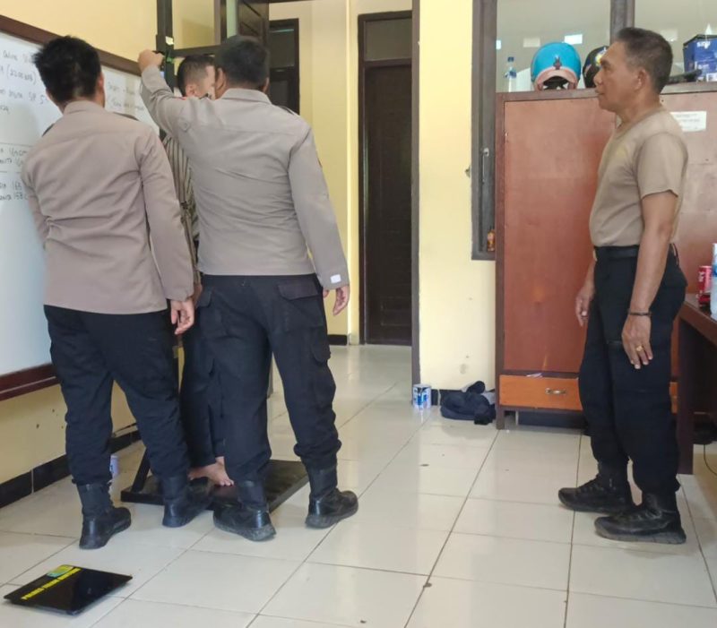 Kompol Safpe Tambatua Sinaga dan Iptu Jimmy Sidete bersama anggota melakukan pengukuran tinggi badan kepada calon Anggota Polri tahun 2024 di Polres Teluk Bintuni, pada Rabu, 17 April 2024. (Foto: Haiser Situmorang)