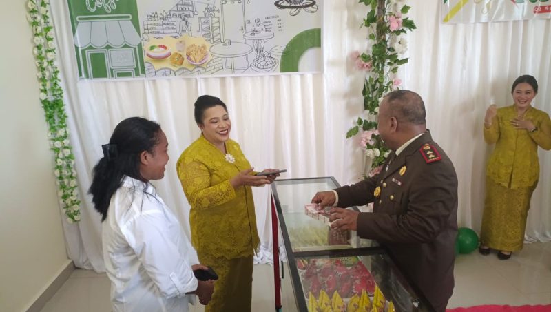 Ketua IAD Teluk Bintuni tampak sedang menghitung harga menggunakan kalkulator saat Kajari membeli satu slop rokok dan hendak membayarnya di Pojok IAD yang baru diresmikan pada hari Senin (2/9) di Kajari Teluk Bintuni.